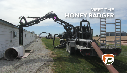 the backside of a Honey Badge with a boom extended into a confinement barn with the title Meet the Honey Badger