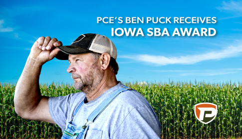 a cornfield in the background with Ben Puck putting on his hat in the foreground and the title reads PCE's Ben Puck Receives Iowa SBA Award