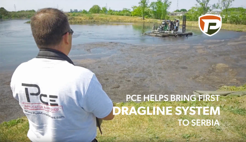 a man watching from the shoreline as a Puck boat agitates a manure lagoon. the title reads PCE Helps Bring First Dragline System to Serbia