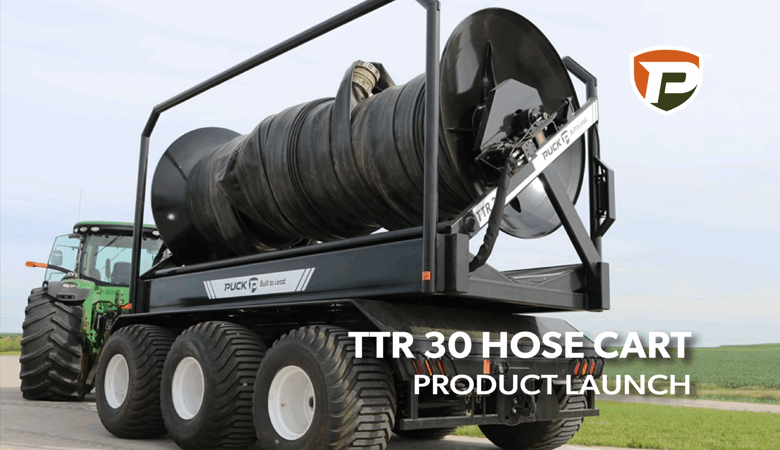 a TTR 30 being pulled by a tractor with large-siameter, black hose with the overlaid title TTR 30 Hose Cart Product Launch