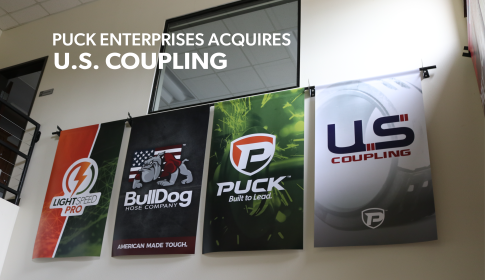 four banners in the Puck Manning lobby with the Family of Brands on each one, from left to right is LightSpeed, BullDog hose Company, Puck Enterprises, and U.S. Coupling. the overlaid title reads Puck Enterprises Acquires U.S. Coupling