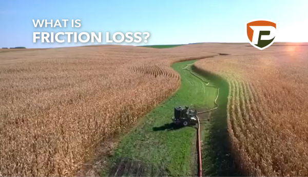 a booster pump in a field between corn rows connected to hoses on either side. What is Friction Loss? is overlaid with the Puck shield logo