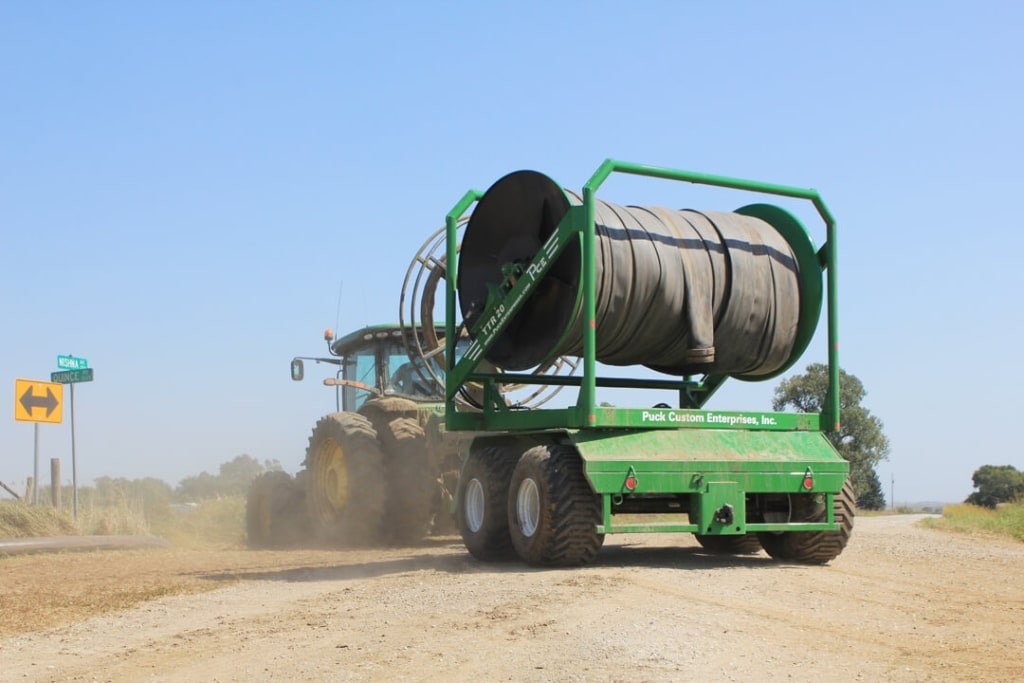 Tractor properly transporting a Puck hose reel