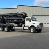 the side of a boom truck manure pump unit folded up for easy transport and storage