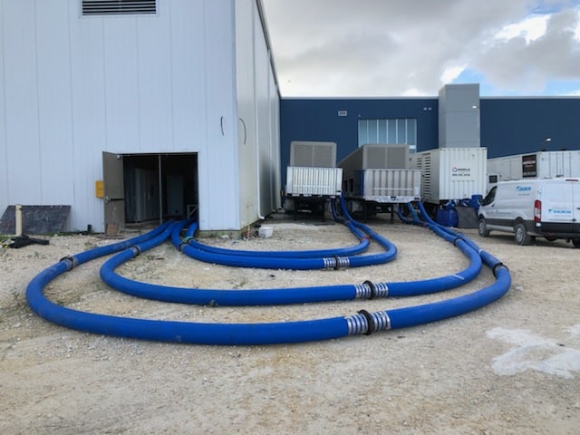 four Chiller hoses connecting 3 mobile Daikin units to the interior of a building