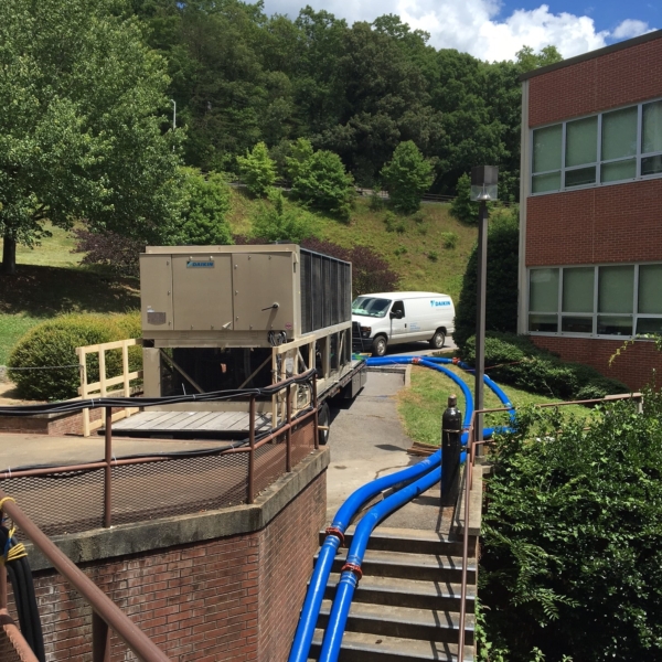two Chiller Hoses in use by Daikin going from a mobile unit and down some stairs into a building