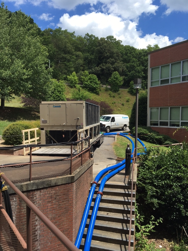 two Chiller Hoses in use by Daikin going from a mobile unit and down some stairs into a building
