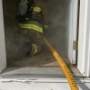 a firefighter entering a smoky hose with the Yellow Chief 1 3/4" supply hose