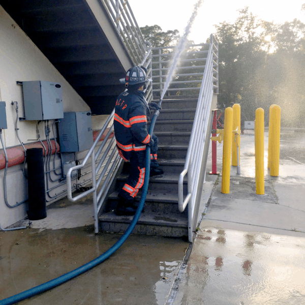 Hi-Power attack hose in use on exterior stairs