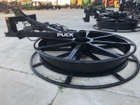 Puck HM10 Hose Mover lying on ground among other equipment