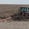 a 3PT toolbar mounted on a tractor with drag hose on the swingarm