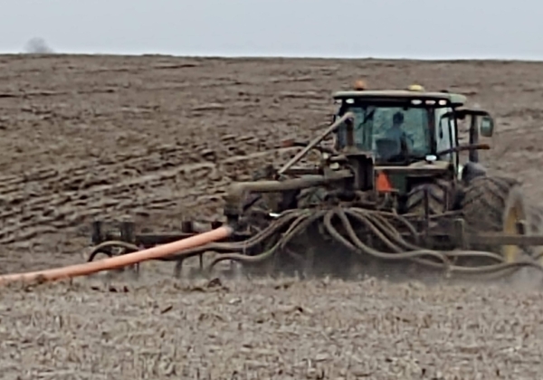 a 3PT toolbar mounted on a tractor with drag hose on the swingarm