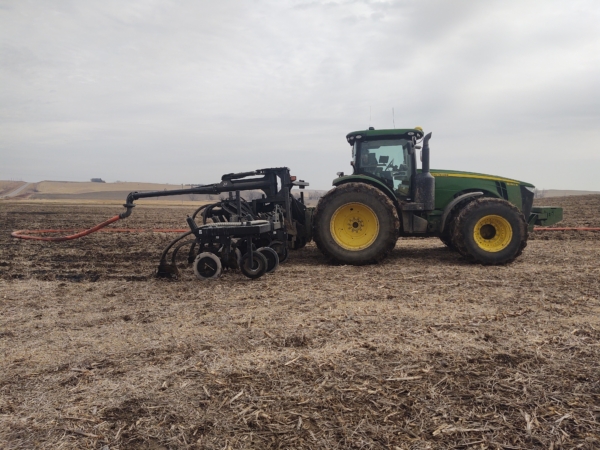 a 3PT toolbar mounted on a tractor with drag hose on the swingarm