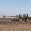 a 4WD toolbar mounted on a tractor with drag hose on the swingarm