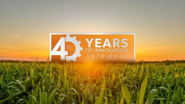 sunset over a crop field with overlaid text that reads "40 years of innovation 1979-2019"