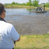 a man watching an agitation boat in a manure lagoon in Serbia