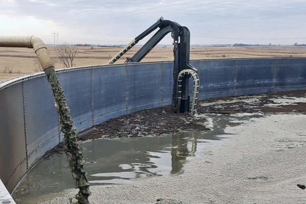 the Agi-Boom agitation trailer displaying the long reach in a manure pit