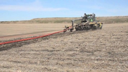 a tractor pulling a dragline