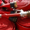 a pile of red hoses rolled up