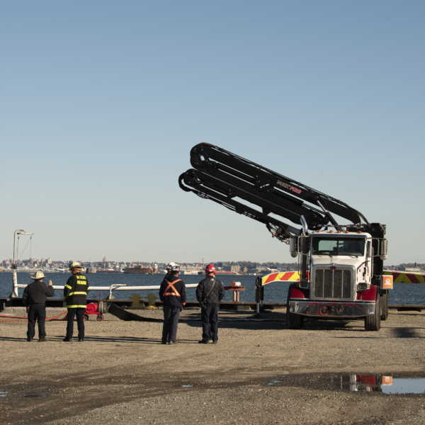 unfolding the hydraulic boom of a Puck Fire boom truck