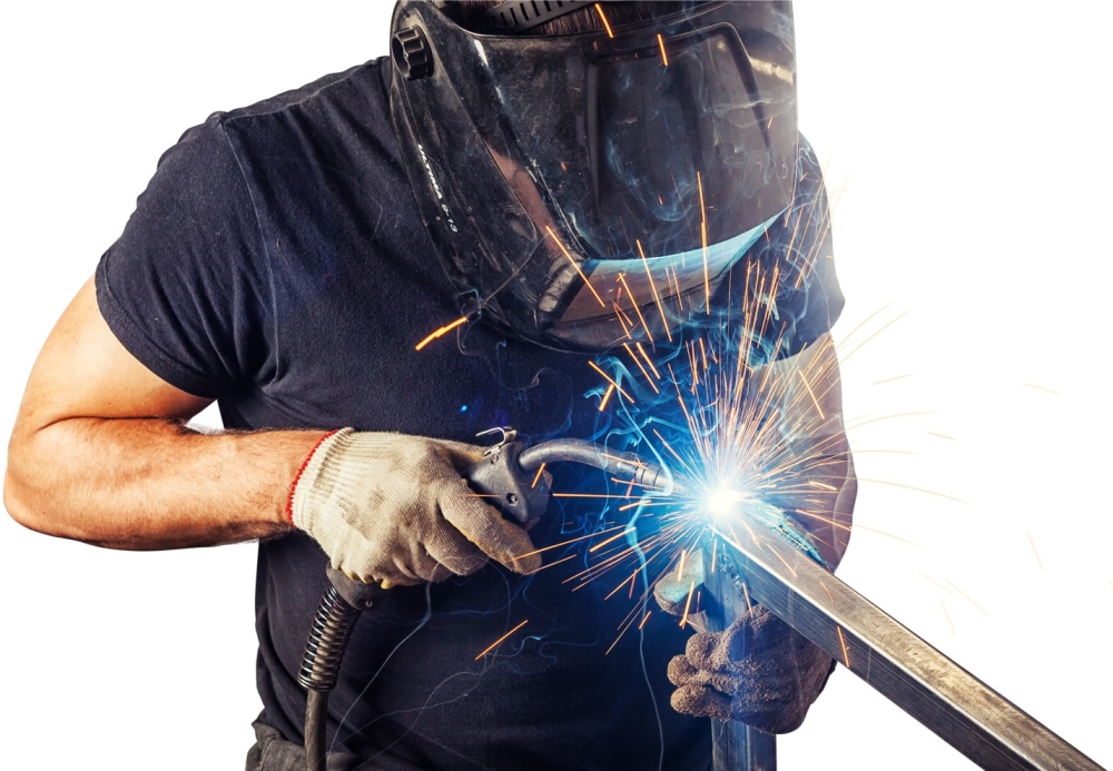 a man welding with full gear on and blue sparks flying