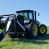 back passenger side view of a Puck HR 4 3PT hose reel on a tractor with black hose on the reel