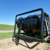back side view of a Puck HR 4 3PT hose reel on a tractor with black hose on the reel