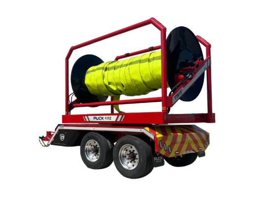 rear driver side view of Puck Fire TTR15P in transport mode with hi-vis TPU supply hose Hi-Vol TPU on the reel