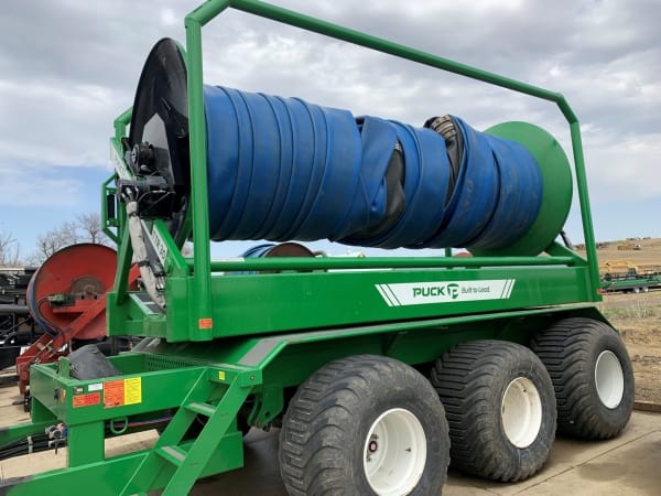 the driver side of a used TTR 30 turn table reel hose cart with a blue hose on the cart
