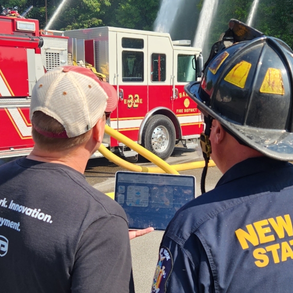 Jeremy Puck showing a fire chief how LightSpeed controls the pumps
