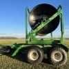 a green 2017 Puck TTR20 turn table reel hose cart parked in a field