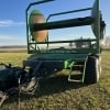 the front of a green 2017 Puck TTR20 turn table reel hose cart parked in a field
