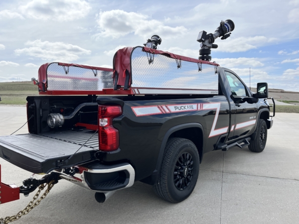 a black truck with Puck Fire Quick Attack apparatus attached to the bed