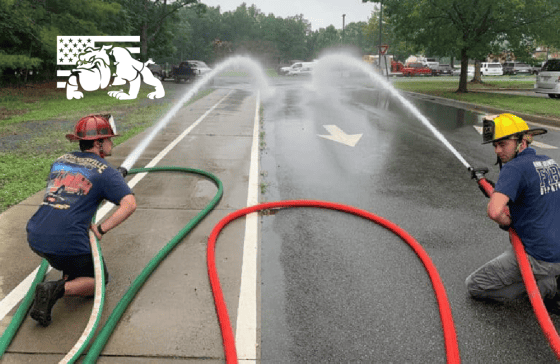 two firefighters testing out BullDog attack hoses in red and green