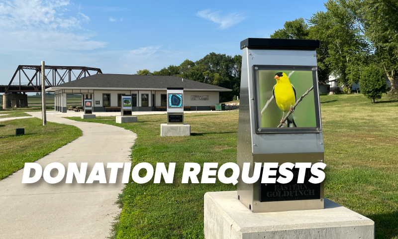 the Iowa state bird, rock, tree, and flower signs outside the Kerkhoff Shelter House at Trestle Park in Manning, Iowa. the signs were made by Puck