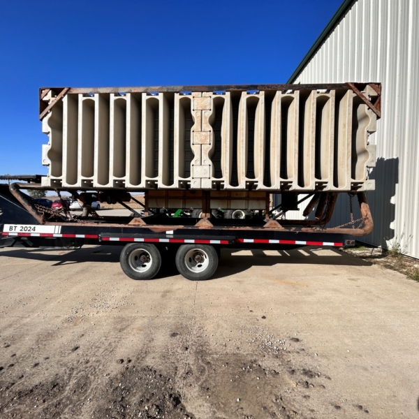 the driver side of a used agitation boat on a boat trailer with flotation devices folded up