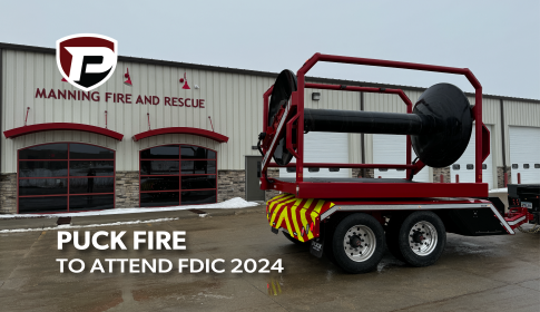 a Puck Fire TTR15P hooked up to a black pick up truck parked in front of the Manning Fire and Rescue with the overlaid title Puck Fire to Attend FDIC 2024