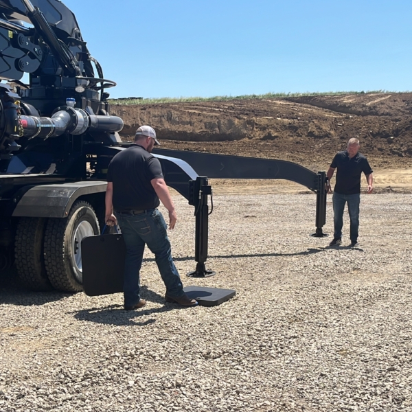 RJ and Doug placing the Cope Plastics outrigger pads under the Boom Truck outriggers