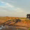 a lagoon feeder sitting on the back of the lagoon as it agitates and is connected via hose to a pump trailer