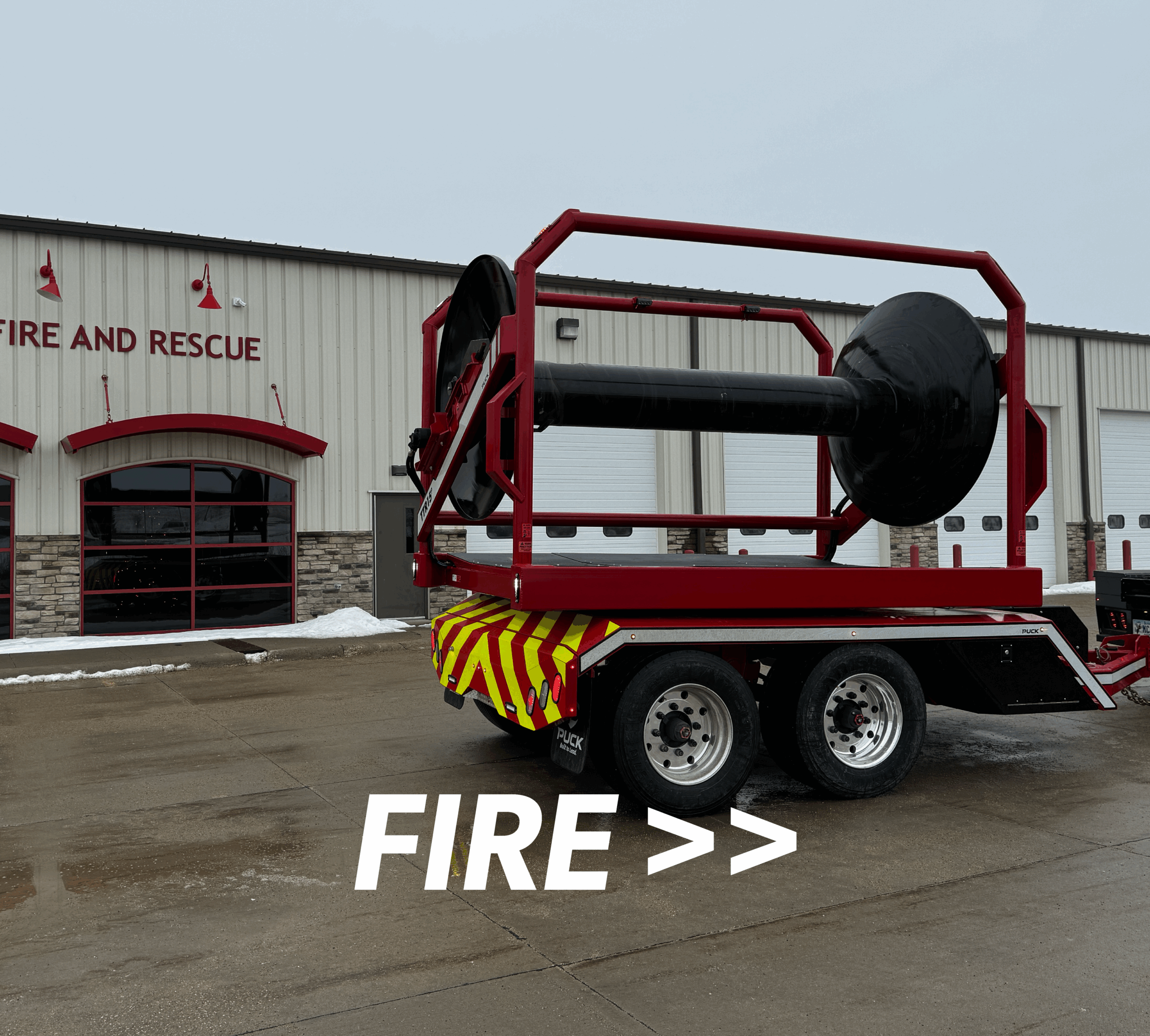 a Puck Fire TTR15P hose reel outside of a fire department