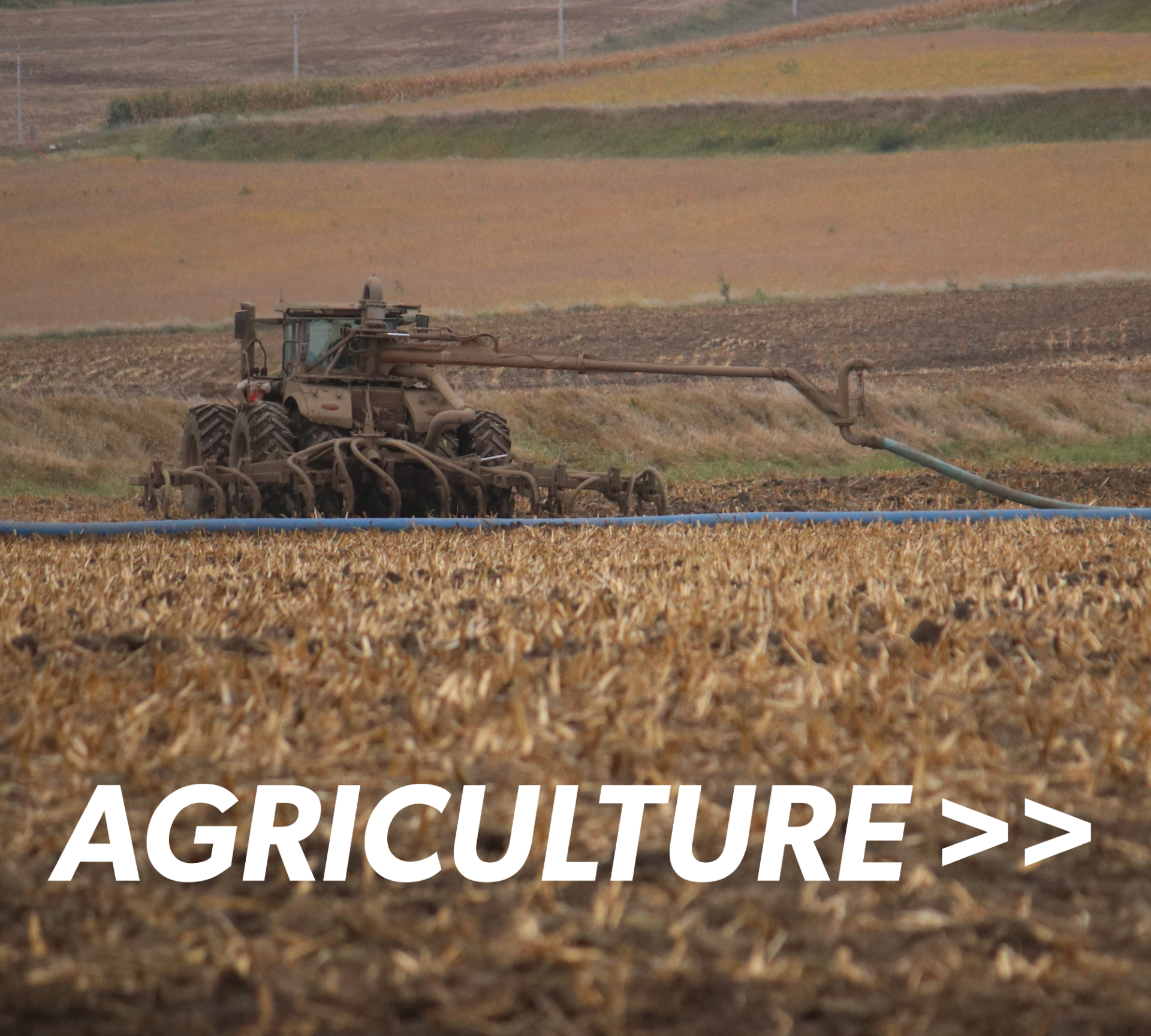 a tractor with a Puck swinger and toolbar attached dragging X24 drag hose through a field with the overlaid title reading Agriculture >>