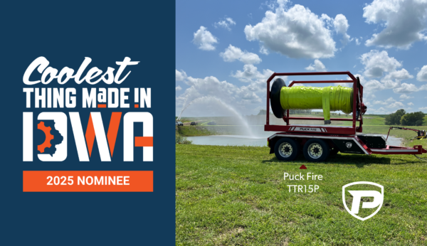 a Puck Fire TTR15P hose cart parked in front of a pond while a FF4500-45 pumps water to a Quick Attack truck spraying water back into the pond. On the left is the logo that reads Coolest Thing Made in Iowa 2025 Nominee