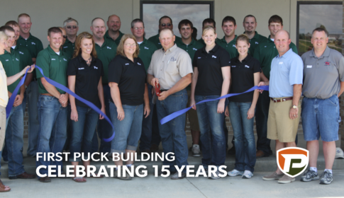 PCE employees in 2010 standing behind Ben and Cathy Puck cutting the ribbon on the grand opening of the first Puck building in Manning