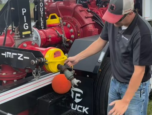 a man opening the pressure relief valve to pig the line on a Puck Fire FF4500-45 Force Feed Trailer