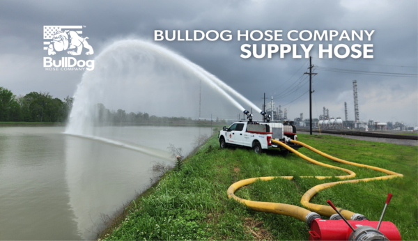 a US Coupling manifold with two BullDog Hi-Vol supply lines connecting the water supply to the dual Storz inlets of a Puck Fire Quick Attack truck that is spraying water into a river