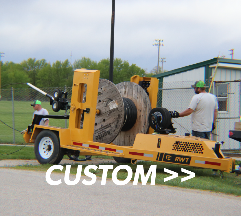 a custom utilities cable reel in use by Manning Municipal to lay cables at new housing development with overlaid title reading Custom>>
