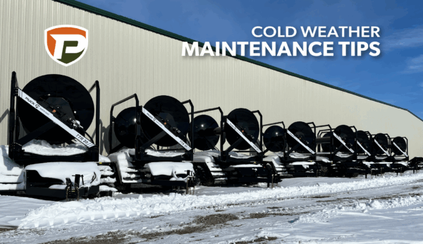 eight TTR 20 hose carts lined up behind a building a covered in snow
