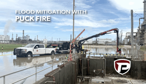 a Puck Fire FF4500-45 Force Feed Trailer sitting in flood water and reaching with its boom to start pumping out water