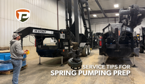 Luke using the remote t move the boom of a Force Feed trailer in the shop
